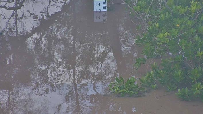 The same water gauge partly submerged in flood water