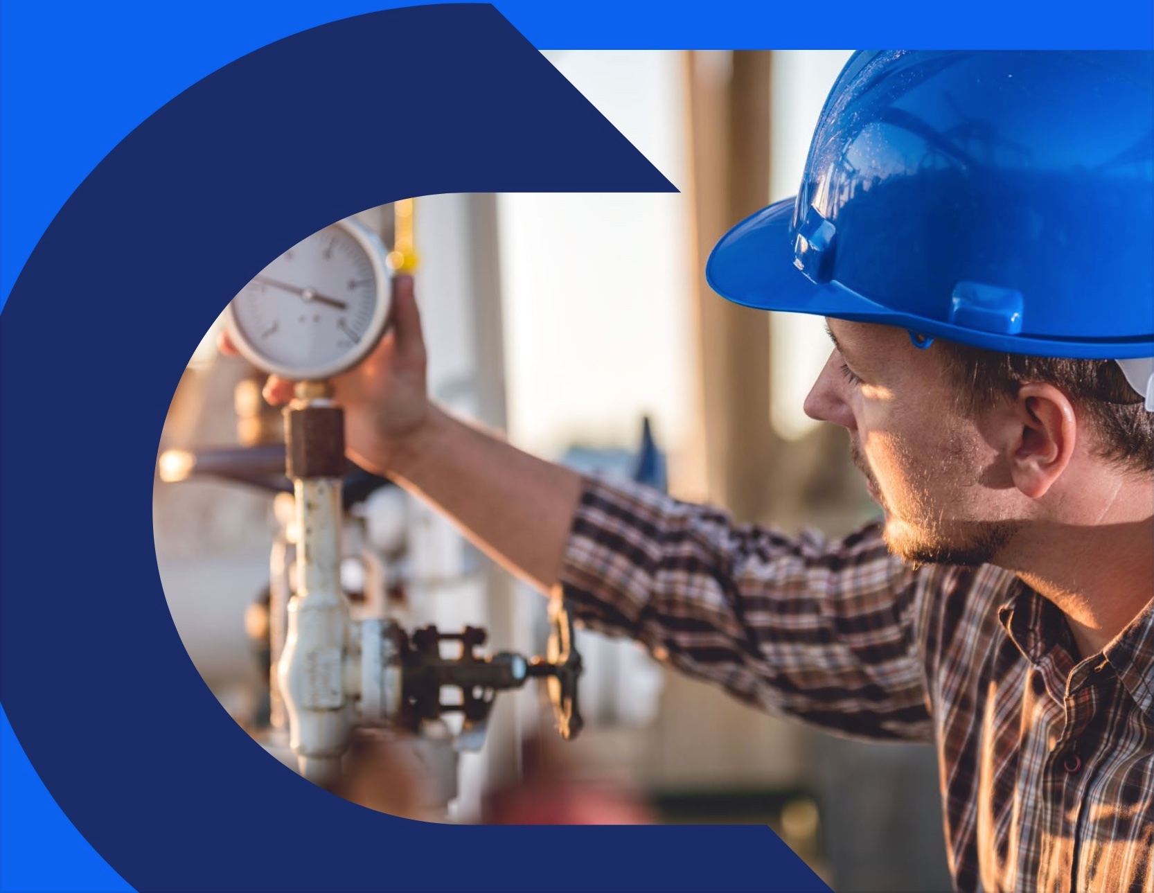 A worker in a hard hat checking a pressure gauge on a pipe